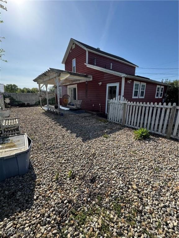 rear view of house featuring a pergola, a patio, and fence private yard