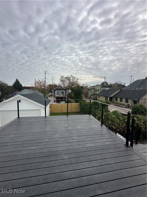 wooden terrace featuring a residential view