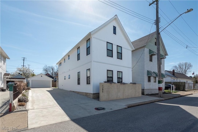 exterior space featuring a garage and an outbuilding