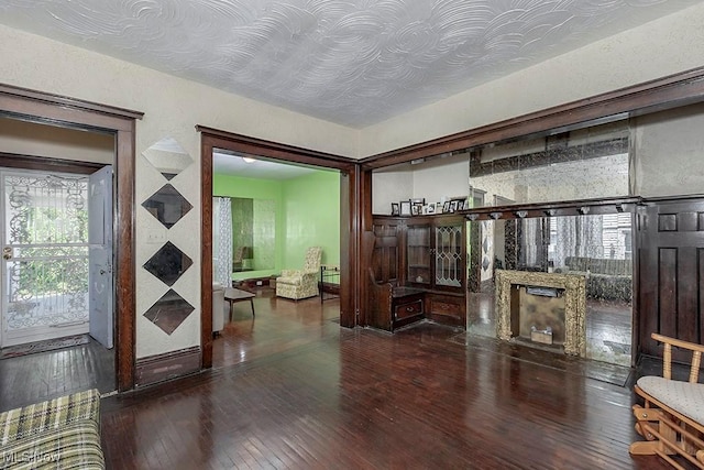 interior space with a fireplace and wood-type flooring