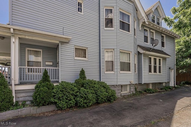 view of property exterior with a porch