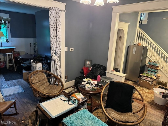 1125 Lafayette St, Zanesville, OH 43701 - dining space with stairway, hardwood / wood-style flooring, and a notable chandelier