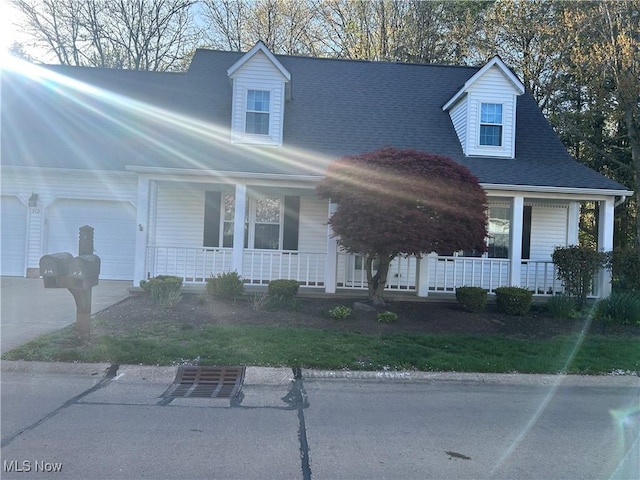 312 Chesapeake Cv, Painesville, OH 44077 - cape cod home with covered porch and a garage