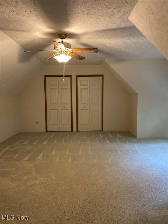 312 Chesapeake Cv, Painesville, OH 44077 - bonus room featuring a ceiling fan, light colored carpet, a textured ceiling, and lofted ceiling