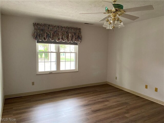 312 Chesapeake Cv, Painesville, OH 44077 - unfurnished room featuring a ceiling fan, wood finished floors, a textured ceiling, and baseboards