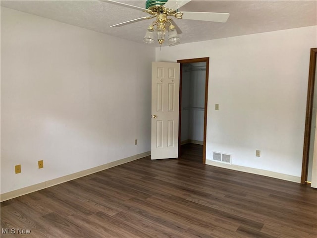 312 Chesapeake Cv, Painesville, OH 44077 - spare room with a ceiling fan, dark wood-type flooring, and baseboards
