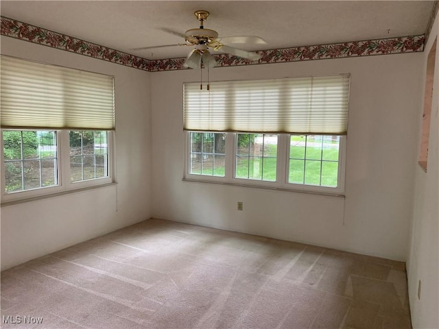 312 Chesapeake Cv, Painesville, OH 44077 - empty room with healthy amount of natural light, light carpet, and a ceiling fan