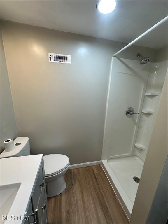 133 Bass Dr, Weirton, WV 26062 - bathroom featuring visible vents, vanity, wood finished floors, toilet, and a stall shower