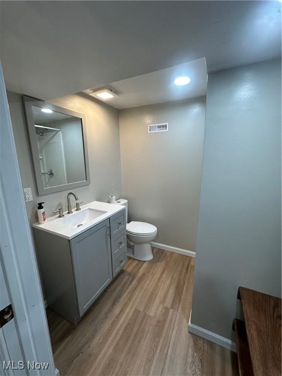 133 Bass Dr, Weirton, WV 26062 - bathroom with vanity, toilet, baseboards, wood finished floors, and visible vents