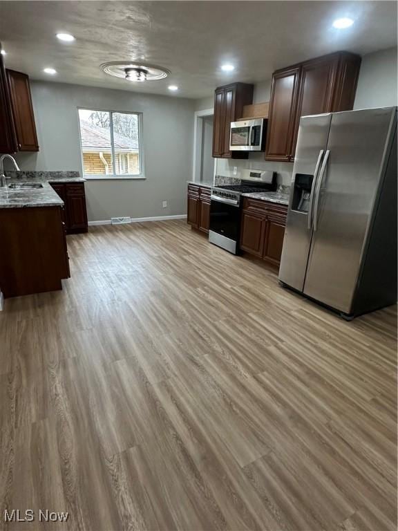 133 Bass Dr, Weirton, WV 26062 - kitchen featuring a sink, stainless steel appliances, and light wood finished floors