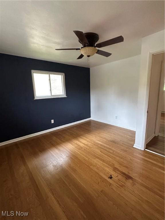 133 Bass Dr, Weirton, WV 26062 - spare room featuring baseboards, a ceiling fan, and wood finished floors