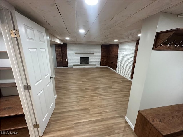 133 Bass Dr, Weirton, WV 26062 - below grade area featuring light wood-style floors, baseboards, and a fireplace