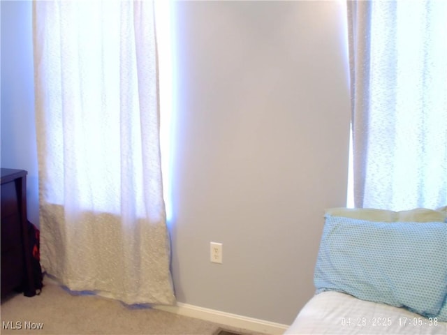 bedroom featuring carpet and baseboards