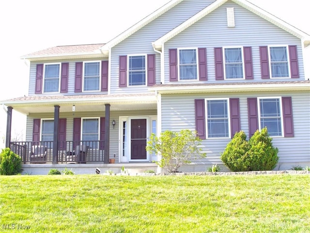 view of front of property with a front yard and covered porch