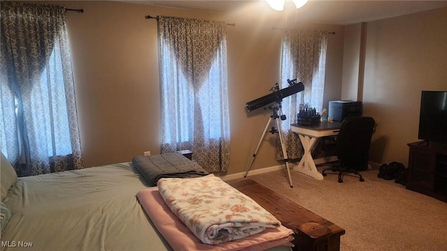 carpeted bedroom with baseboards