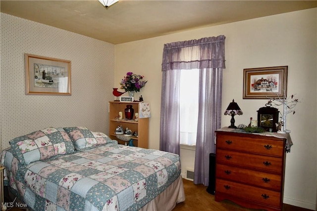 bedroom featuring dark colored carpet