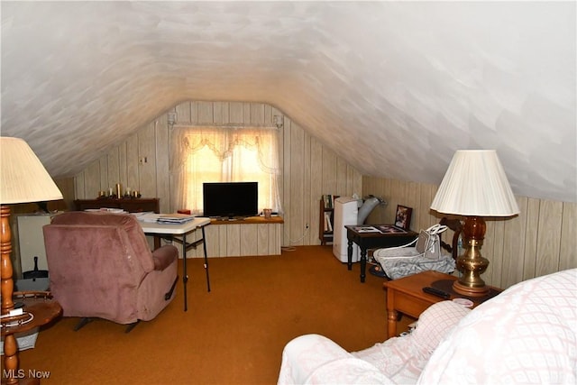 carpeted bedroom featuring wooden walls and vaulted ceiling