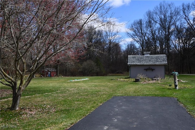 view of yard featuring an outdoor structure and a shed