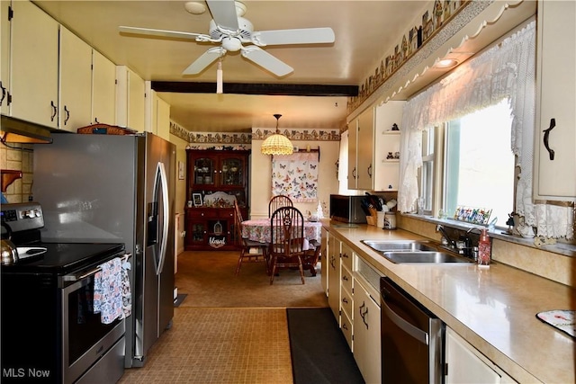 kitchen with ceiling fan, appliances with stainless steel finishes, open shelves, light countertops, and a sink