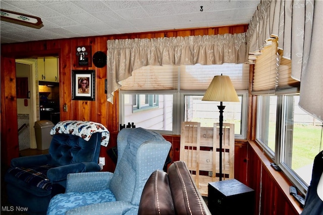 living area featuring wooden walls