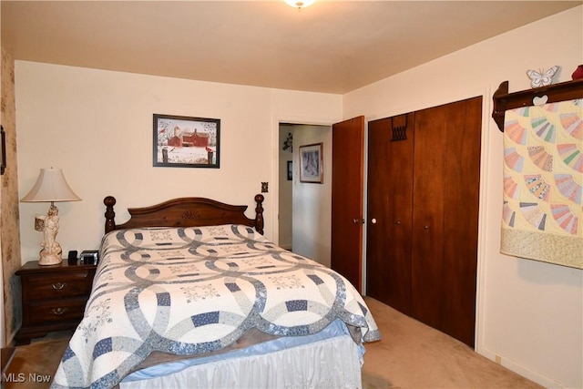 bedroom with carpet and a closet