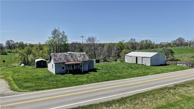 exterior space with a lawn, a pole building, and an outbuilding