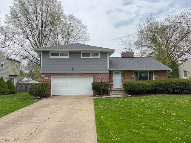 split level home featuring fence, an attached garage, brick siding, a front yard, and driveway