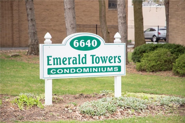 community / neighborhood sign with fence