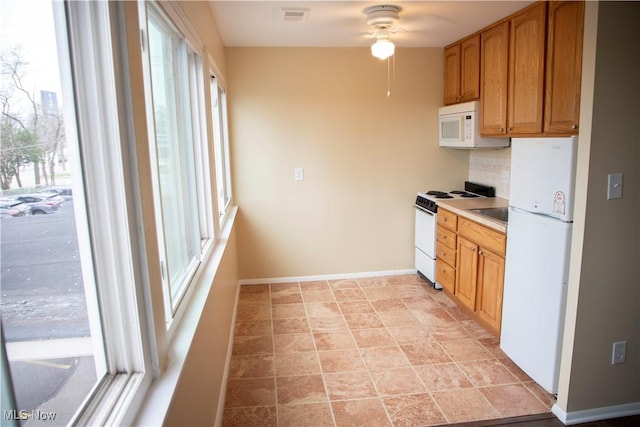 kitchen featuring a ceiling fan, visible vents, tasteful backsplash, baseboards, and white appliances