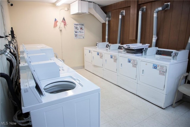 common laundry area with light floors and washing machine and clothes dryer