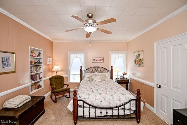 bedroom with crown molding, carpet, and multiple windows