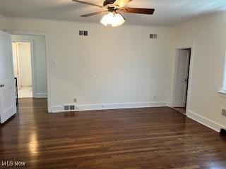 unfurnished room featuring baseboards, a ceiling fan, and wood finished floors