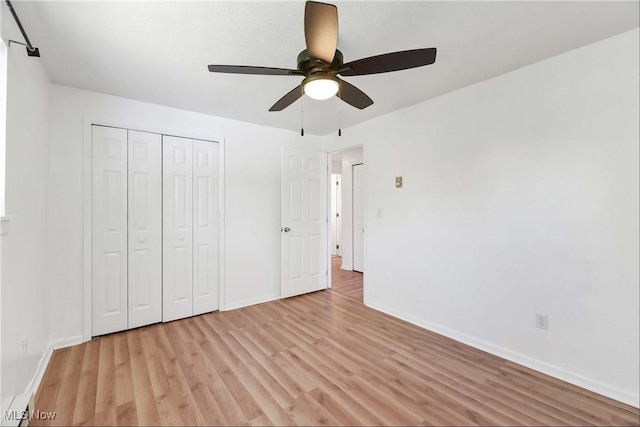 unfurnished bedroom featuring a closet, baseboards, ceiling fan, and light wood-type flooring