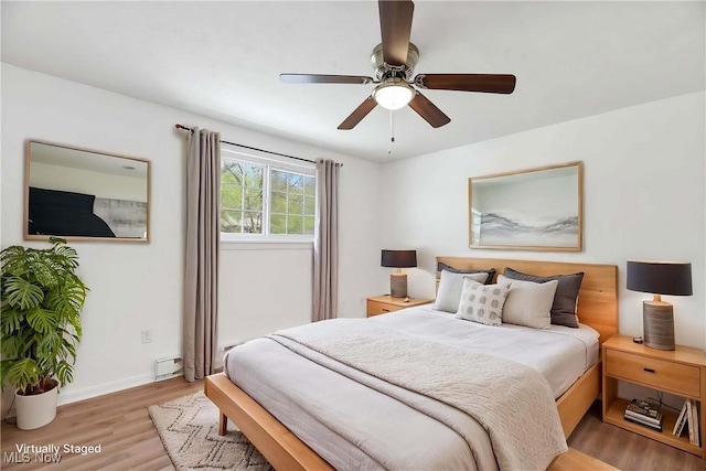 bedroom featuring baseboards, ceiling fan, and light wood-type flooring