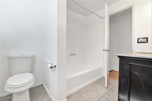 full bath featuring tile patterned flooring, vanity, shower / bathtub combination, toilet, and baseboards