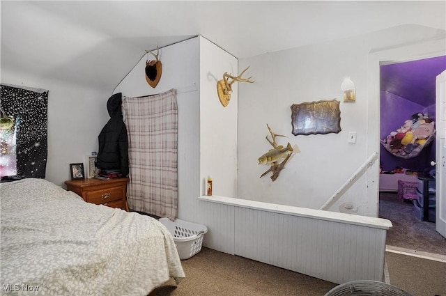 bedroom featuring vaulted ceiling and carpet
