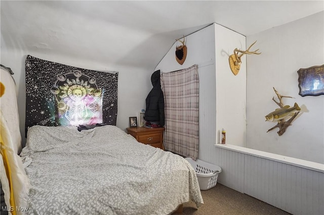carpeted bedroom with lofted ceiling