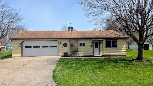 ranch-style house with a garage, roof with shingles, driveway, and a front lawn