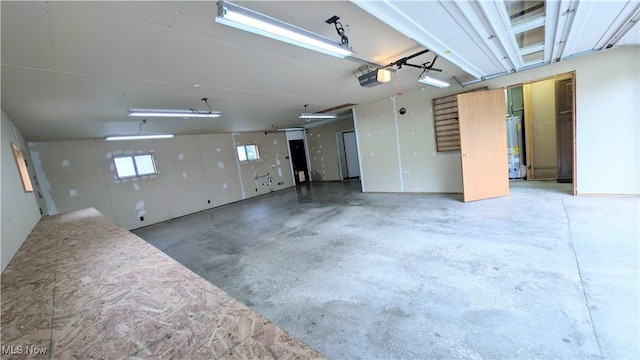 garage with water heater and a garage door opener