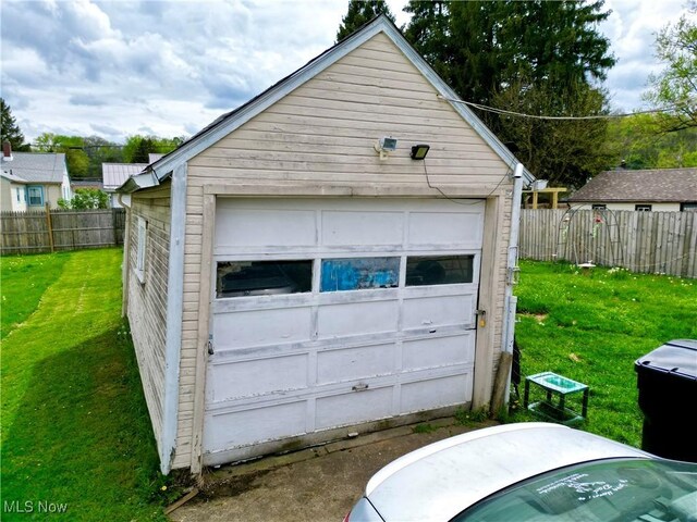 detached garage featuring fence