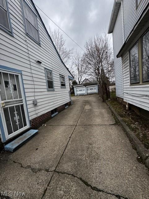 view of side of home featuring an outbuilding