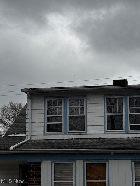 view of home's exterior with roof with shingles