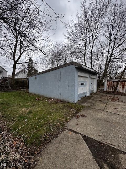 view of outbuilding with fence and an outbuilding