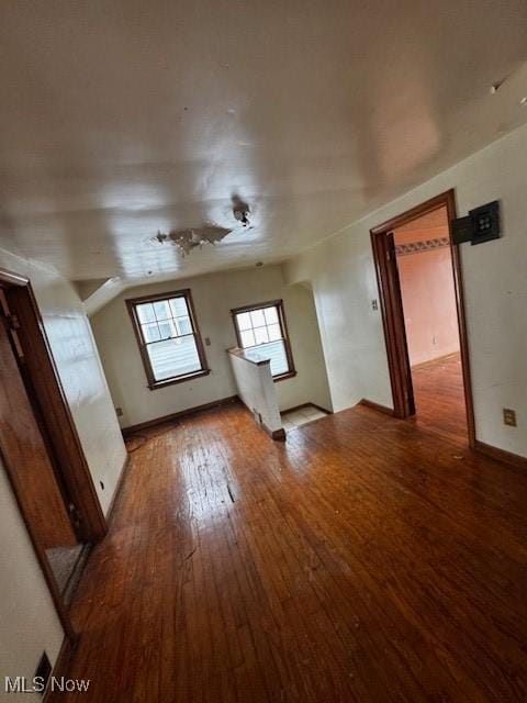 interior space featuring baseboards and hardwood / wood-style floors