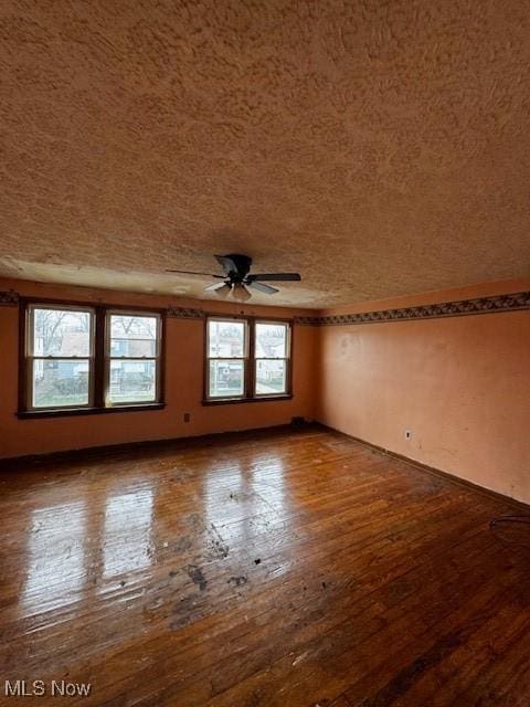 unfurnished room with ceiling fan and hardwood / wood-style floors