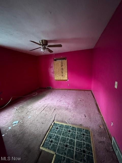 interior space with visible vents, carpet, and ceiling fan