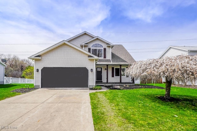 traditional-style house featuring concrete driveway, an attached garage, fence, and a front lawn