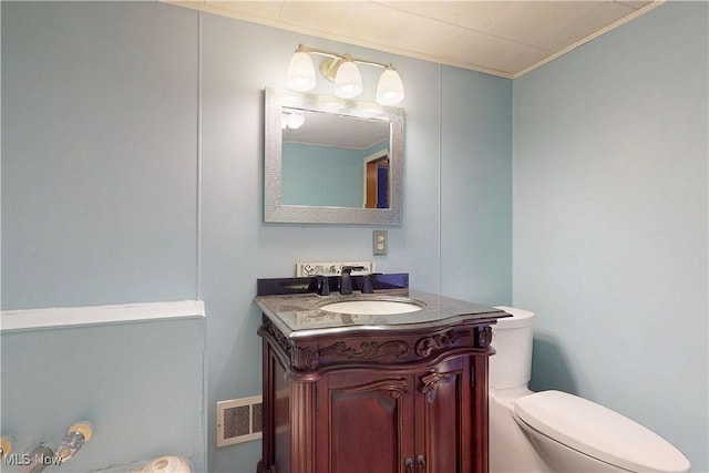 441 4th St, Bergholz, OH 43908 - bathroom featuring visible vents, ornamental molding, toilet, and vanity
