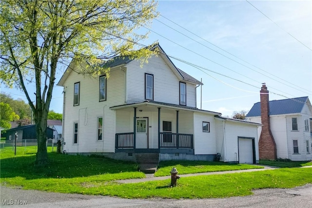 441 4th St, Bergholz, OH 43908 - view of front of home with a garage, covered porch, and a front yard