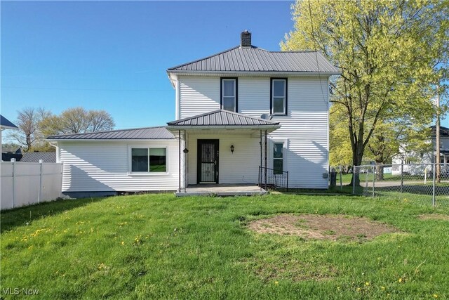 441 4th St, Bergholz, OH 43908 - rear view of house with fence, a chimney, a yard, and metal roof